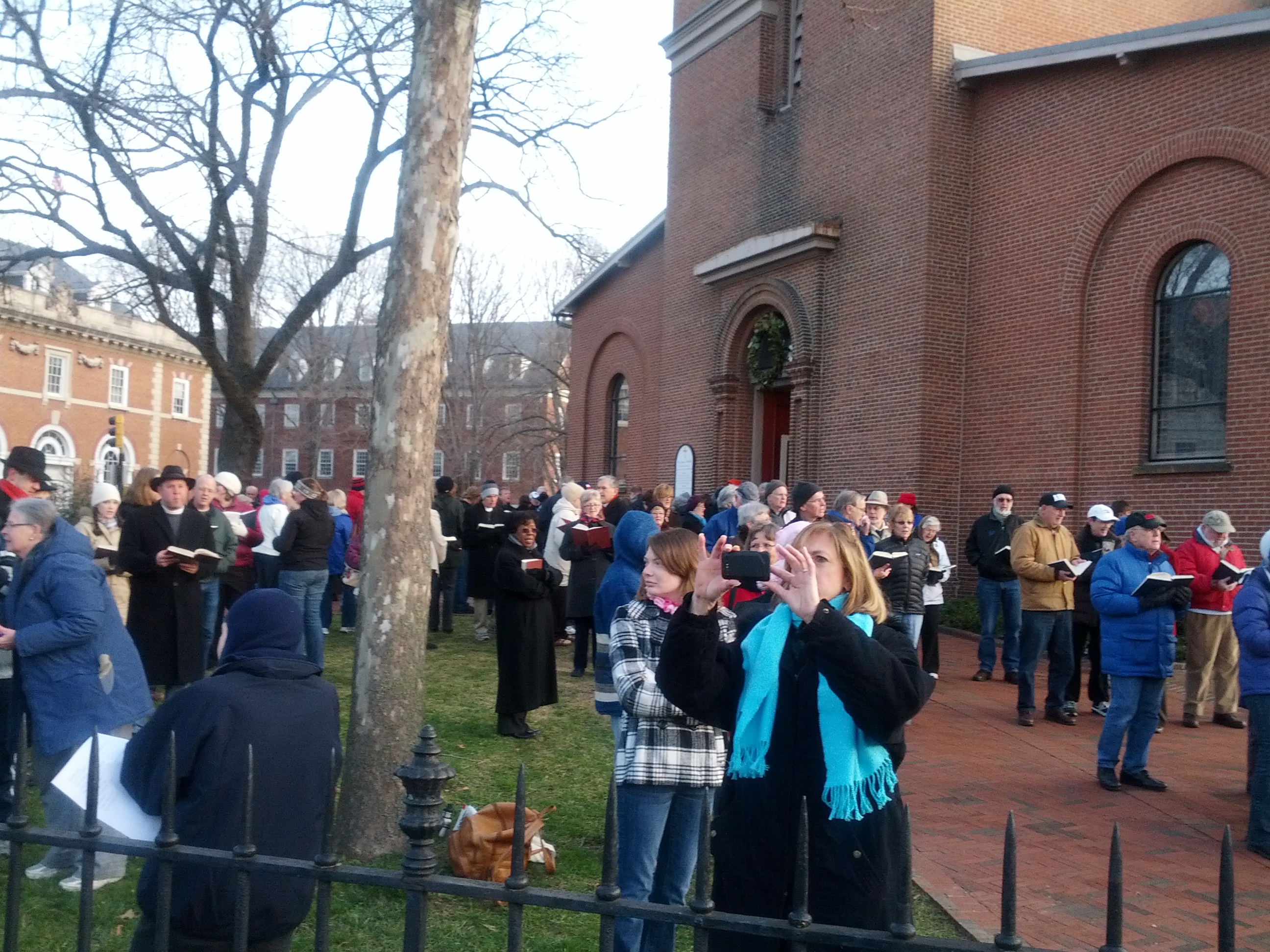 People gathered outside St. Anne's Parish in Annapolis. St. Anne's set up an amplified piano outside its doors, and members of the church & public sang hymns as part of the counter protest.
